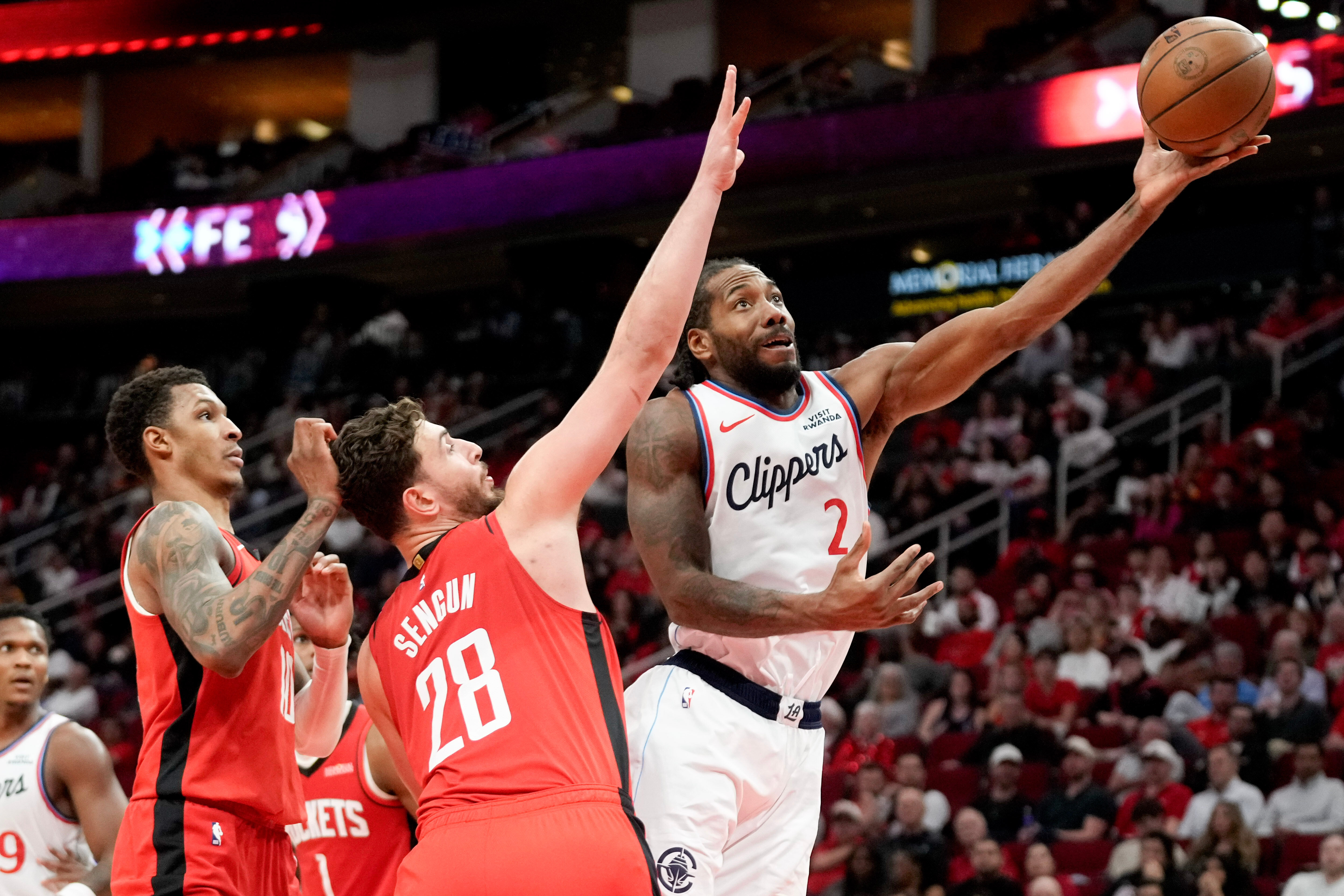 Clippers star Kawhi Leonard shoots as Houston Rockets center Alperen...