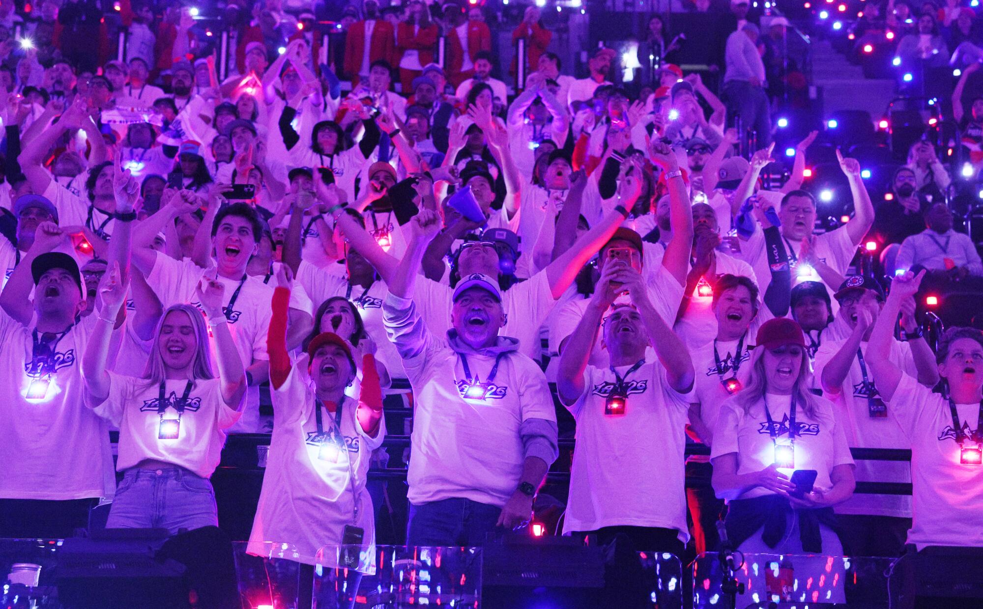 Fans cheer are illuminated by Intuit Dome lights as they cheer during all-star festivities Saturday.