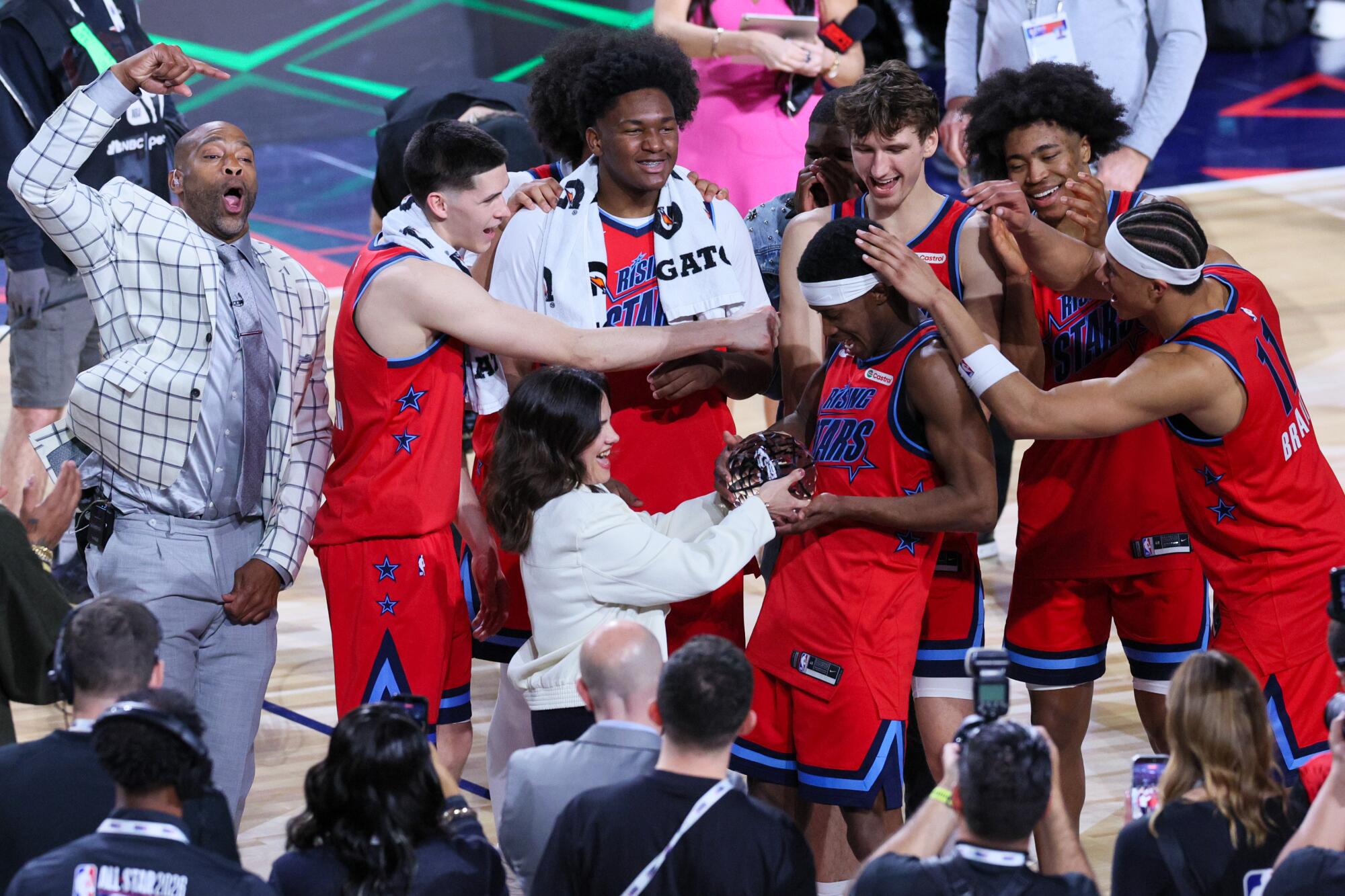 Team Vince Carter celebrates as Philadelphia 76ers guard VJ Edgecombe wins rising stars game most valuable player honor.