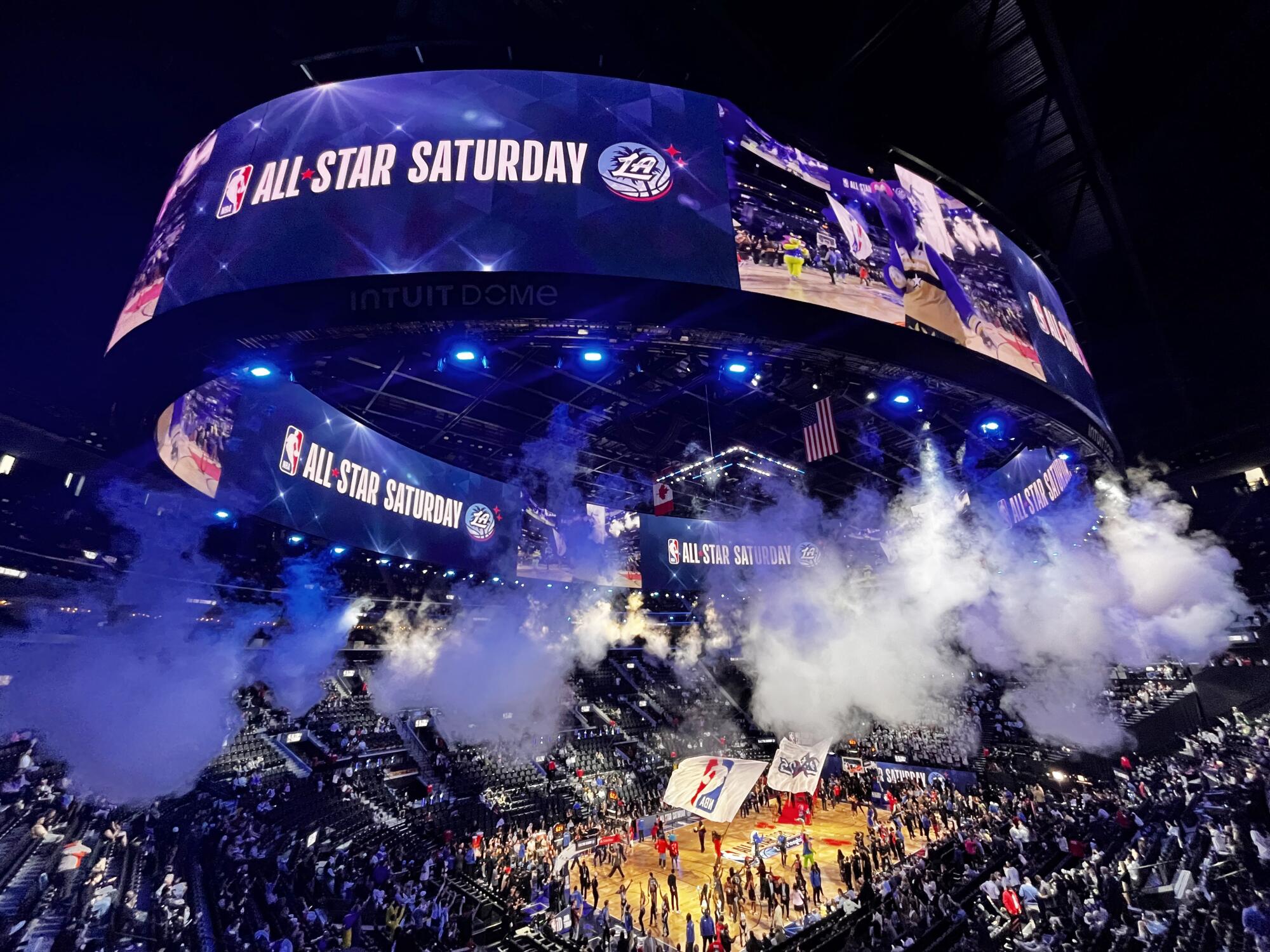 Smoke fills and lights are deployed during the NBA All-Star events Saturday at the Intuit Dome in Inglewood.