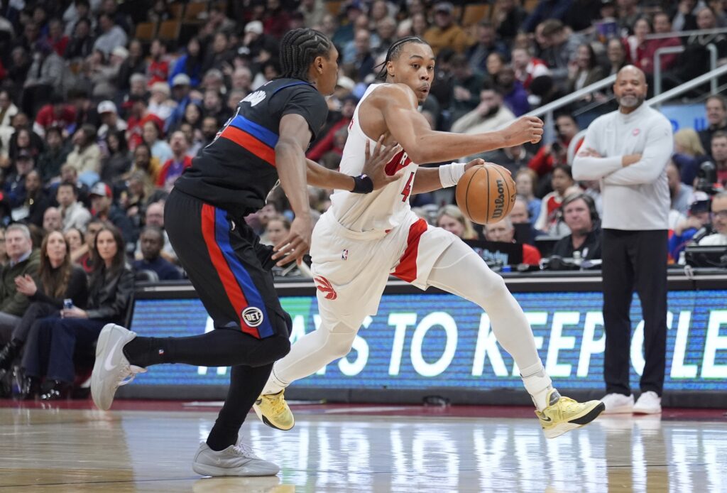 Toronto Raptors guard Scottie Barnes (4) tries to dribble around Detroit Pistons forward Ausar Thompson (9) during the second half at Scotiabank Arena.