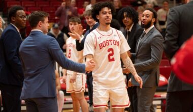 Otto Landrum and Ben Roy gather with head coach Joe Jones and family for a pregame Senior Day photo