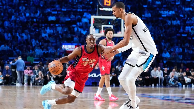 USA Stars guard Tyrese Maxey, left, is defended by World...