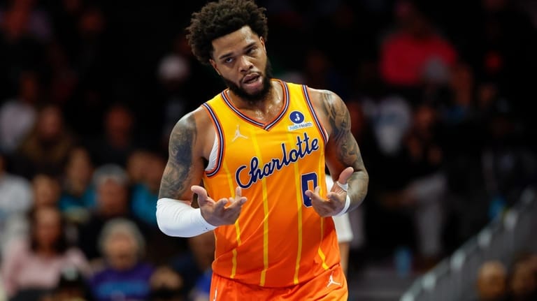 Charlotte Hornets forward Miles Bridges makes the "6-7" motion after...