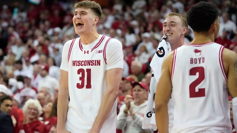 Wisconsin forward Nolan Winter (31) and Andrew Rohde, second from...