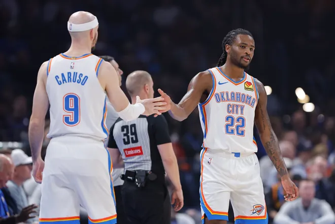 Feb 12, 2026; Oklahoma City, Oklahoma, USA; Oklahoma City Thunder guard Cason Wallace (22) and guard Alex Caruso (9) high five after a play against the Milwaukee Bucks during the first half at Paycom Center. Mandatory Credit: Alonzo Adams-Imagn Images