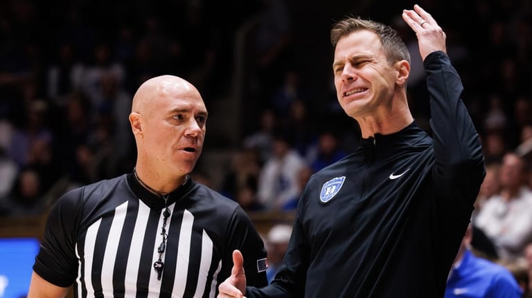 Duke head coach Jon Scheyer, right, reacts to a call...