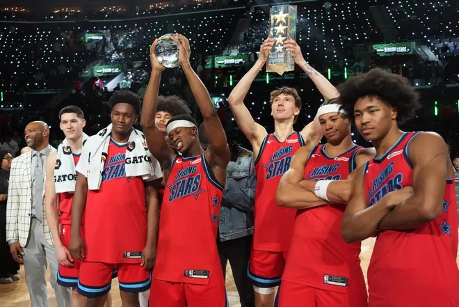 Feb 13, 2026; Inglewood, California, USA; Team Vince VJ Edgecombe (77) of the Philadelphia 76ers celebrates with teammates after defeating Team Melo in an NBA All Star Rising Stars championship game at Intuit Dome.