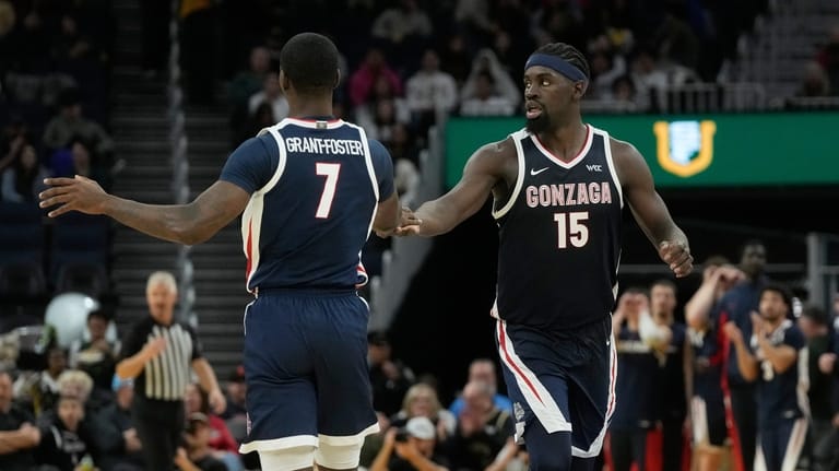 Gonzaga guard Tyon Grant-Foster (7) celebrates with forward Graham Ike...