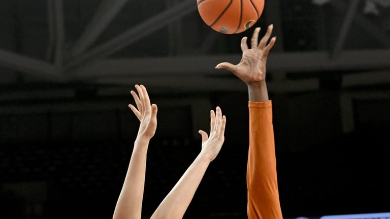 Texas center Kyla Oldacre (00) shoots over Arkansas center Ashlynn...