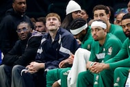 Dallas Mavericks forward Cooper Flagg (32), second from left, sits on the bench during the...