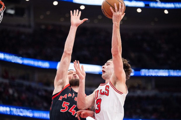 Chicago Bulls guard Josh Giddey (3) goes for a layup over Toronto Raptors forward Sandro Mamukelashvili (54) in the second half of a game against the Toronto Raptors at the United Center in Chicago on Feb. 19, 2026. (Josh Boland/Chicago Tribune)