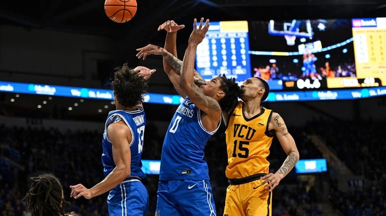 Saint Louis' Dion Brown (13) and Kellen Thames (0) defend...