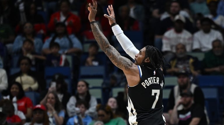Milwaukee Bucks guard-forward Kevin Porter Jr. (7) shoots the ball...