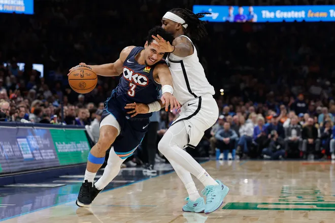 Feb 20, 2026; Oklahoma City, Oklahoma, USA; Oklahoma City Thunder guard Jared McCain (3) drives past Brooklyn Nets guard/forward Terance Mann (14) during the second half at Paycom Center. Mandatory Credit: Alonzo Adams-Imagn Images