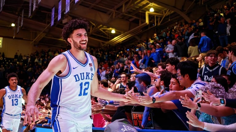Duke's Cameron Boozer (12) greets fans after his team defeated...
