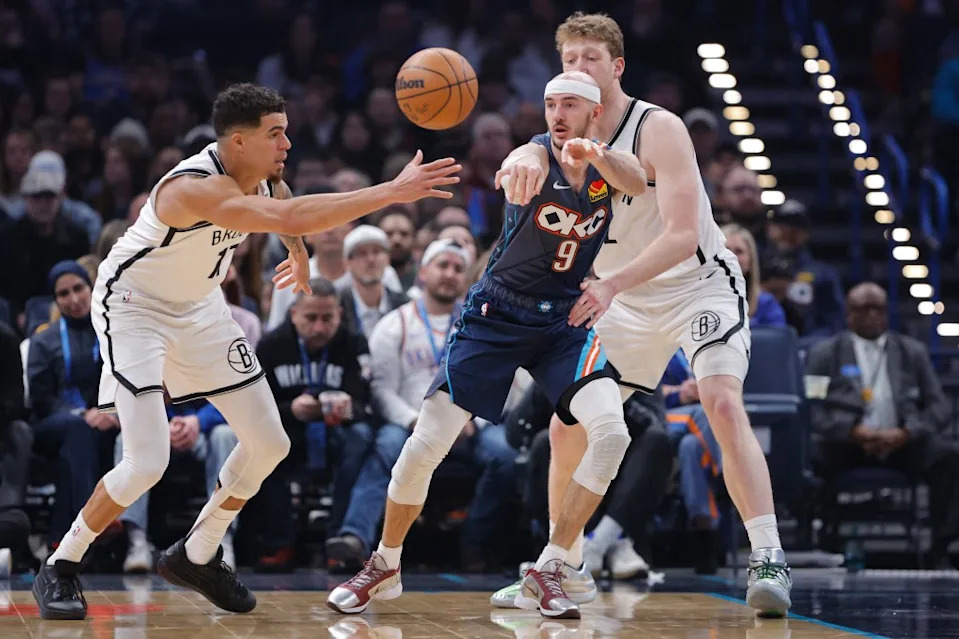 Alex Caruso (9) passes as Michael Porter Jr. (17) defends during the first half of the Nets’ 105-86 loss to the Thunder at Paycom Center on Feb. 20, 2026 in Oklahoma City. IMAGN IMAGES via Reuters Connect