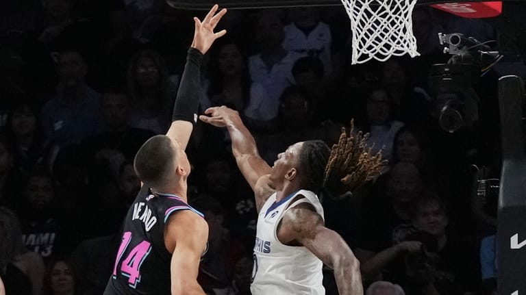 Miami Heat guard Tyler Herro (14) shoots as Memphis Grizzlies...