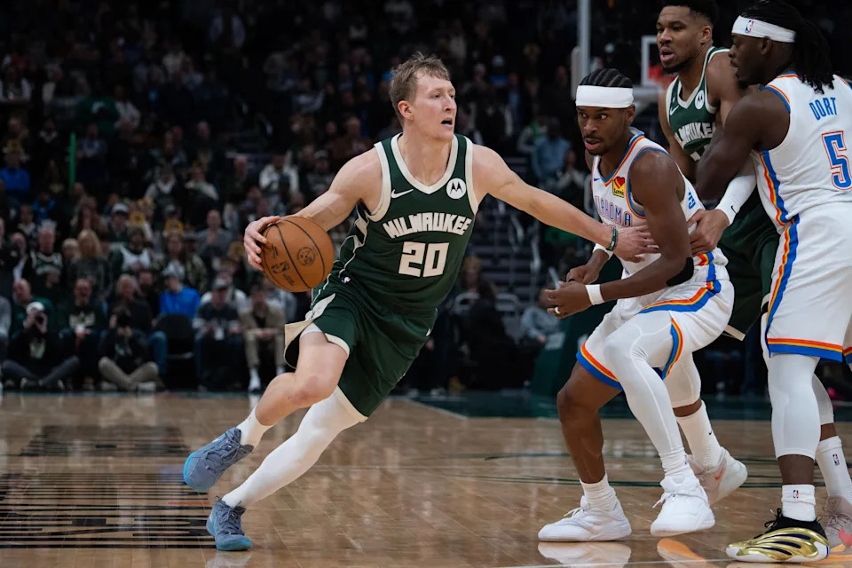 Milwaukee Bucks guard AJ Green (20) dribbles past the Oklahoma City Thunder guard Shai Gilgeous-Alexander (2) in the first half at Fiserv Forum on the evening of Jan. 21, 2026 in Milwaukee, Wisconsin.
