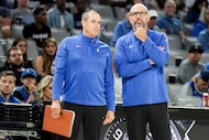 Dallas Mavericks Head Coach Jason Kidd (right) looks out from the bench with assistant coach...