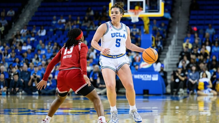 UCLA guard Charlisse Leger-Walker (5) controls the ball while under...