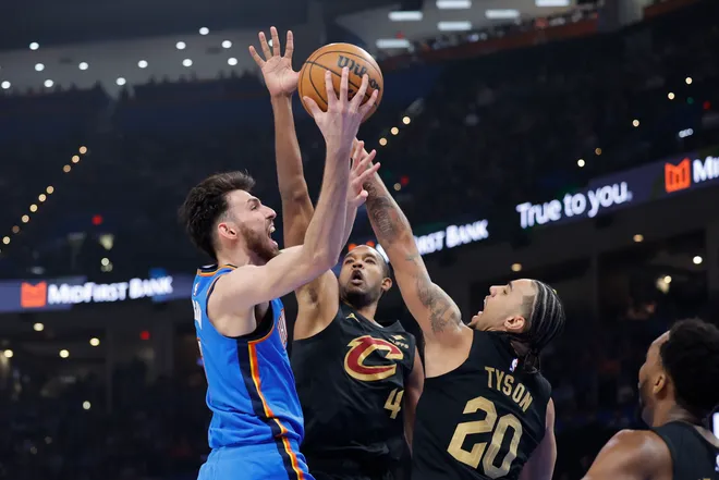 Feb 22, 2026; Oklahoma City, Oklahoma, USA; Oklahoma City Thunder center/forward Chet Holmgren (7) goes up for a basket as Cleveland Cavaliers guard Jaylon Tyson (20) and center Evan Mobley (4) defend during the first half at Paycom Center. Mandatory Credit: Alonzo Adams-Imagn Images
