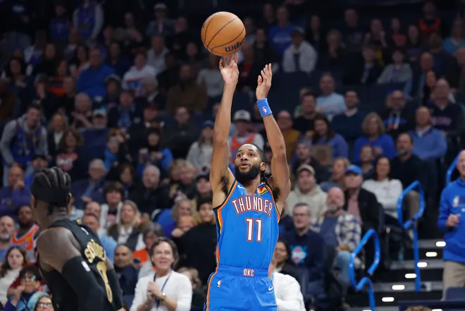 Feb 22, 2026; Oklahoma City, Oklahoma, USA; Oklahoma City Thunder guard Isaiah Joe (11) shoots a three point basket against the Cleveland Cavaliers during the first half at Paycom Center. Mandatory Credit: Alonzo Adams-Imagn Images