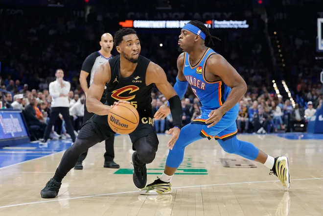 Feb 22, 2026; Oklahoma City, Oklahoma, USA; Cleveland Cavaliers guard Donovan Mitchell (45) drives around Oklahoma City Thunder guard Luguentz Dort (5) during the second half at Paycom Center. Mandatory Credit: Alonzo Adams-Imagn Images