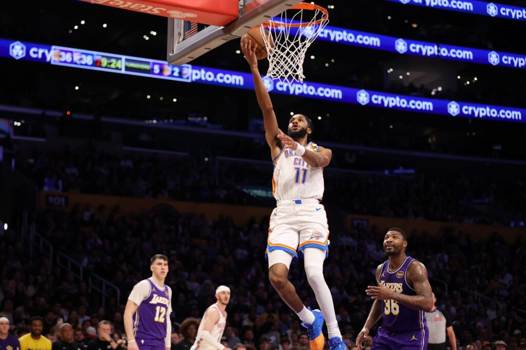 Feb 9, 2026; Los Angeles, California, USA; Oklahoma City Thunder guard Isaiah Joe (11) goes to the basket past Los Angeles Lakers guard Marcus Smart (36) during the second quarter at Crypto.com Arena. Mandatory Credit: Kiyoshi Mio-Imagn Images
