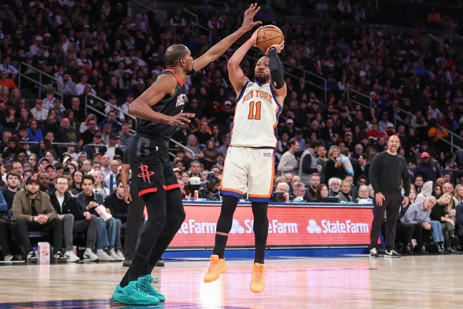Feb 21, 2026; New York, New York, USA; New York Knicks guard Jalen Brunson (11) shoots past Houston Rockets forward Kevin Durant (7) in the third quarter at Madison Square Garden.