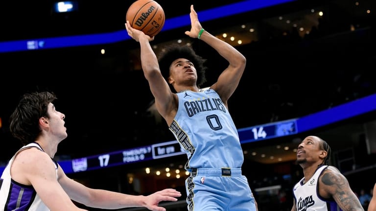 Memphis Grizzlies forward Jaylen Wells (0) shoots between Sacramento Kings...