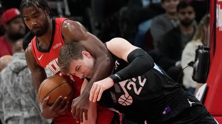 Houston Rockets forward Tari Eason, left, grabs a rebound against...