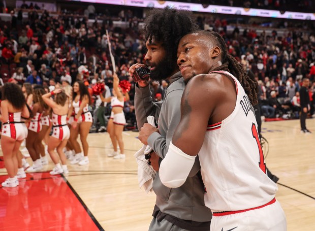 Bulls guard Ayo Dosunmu, right, hugs guard Coby White after beating he Hawks on Oct. 27, 2025, at the United Center. (Dominic Di Palermo/Chicago Tribune)