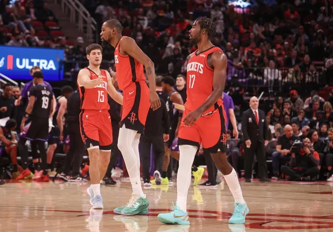 Feb 23, 2026; Houston, Texas, USA; Houston Rockets guard Reed Sheppard (15) celebrates forward Kevin Durant (7) and forward Tari Eason (17) play against the Utah Jazz in the second quarter at Toyota Center.