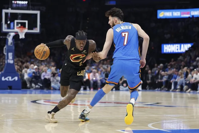 Feb 22, 2026; Oklahoma City, Oklahoma, USA; Cleveland Cavaliers guard Dennis Schroder (8) drives around Oklahoma City Thunder center/forward Chet Holmgren (7) during the second half at Paycom Center.