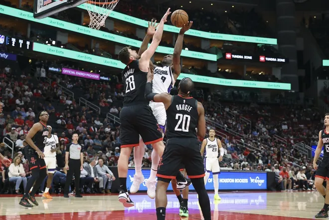 Feb 25, 2026; Houston, Texas, USA; Sacramento Kings forward Precious Achiuwa (9) shoots the ball as Houston Rockets center Alperen Sengun (28) defends during the fourth quarter at Toyota Center.