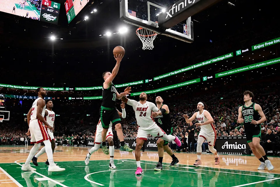 Feb 6, 2026; Boston, Massachusetts, USA; Boston Celtics guard Payton Pritchard (11) drives to the basket past Miami Heat guard Norman Powell (24) during the second half at TD Garden. Mandatory Credit: Bob DeChiara-Imagn Images