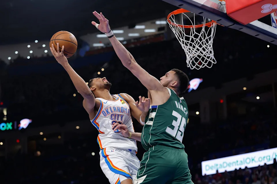 Feb 12, 2026; Oklahoma City, Oklahoma, USA; Oklahoma City Thunder guard Aaron Wiggins (21) shoots as Milwaukee Bucks forward Pete Nance (35) defends during the second half at Paycom Center. Mandatory Credit: Alonzo Adams-Imagn Images