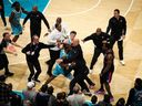 Charlotte's Moussa Diabate (center) is restrained after clashing with Detroit's Miles Bridges in their stormy NBA clash.