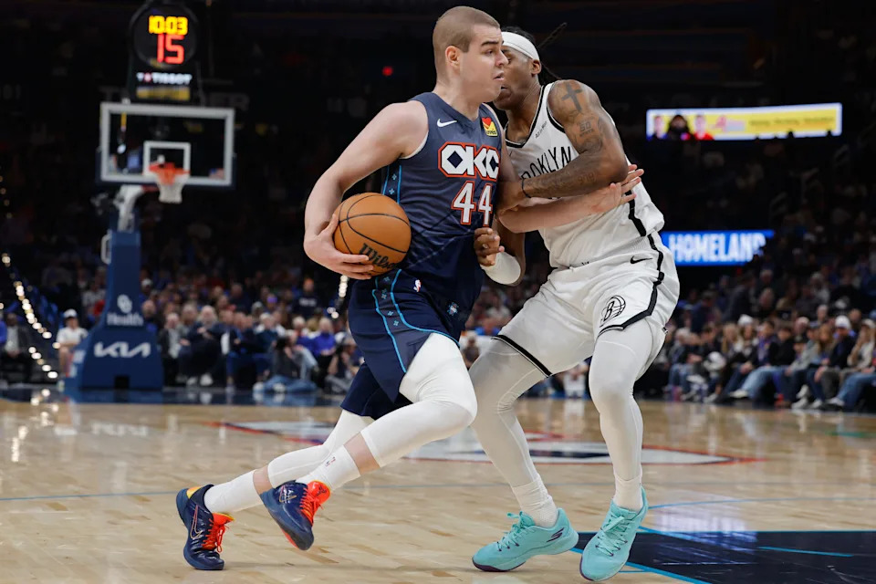 Feb 20, 2026; Oklahoma City, Oklahoma, USA; Oklahoma City Thunder guard Nikola Topić (44) drives past Brooklyn Nets guard/forward Terance Mann (14) during the second half at Paycom Center. Mandatory Credit: Alonzo Adams-Imagn Images