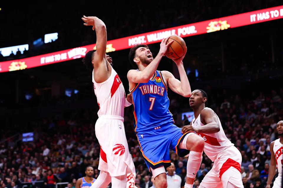 TORONTO, CANADA - FEBRUARY 24: Chet Holmgren #7 of the Oklahoma City Thunder goes to the net between Scottie Barnes #4 and RJ Barrett #9 of the Toronto Raptors during the second half of their NBA game at Scotiabank Arena on February 24, 2026 in Toronto, Ontario, Canada. NOTE TO USER: User expressly acknowledges and agrees that, by downloading and or using this photograph, User is consenting to the terms and conditions of the Getty Images License Agreement. (Photo by Cole Burston/Getty Images)