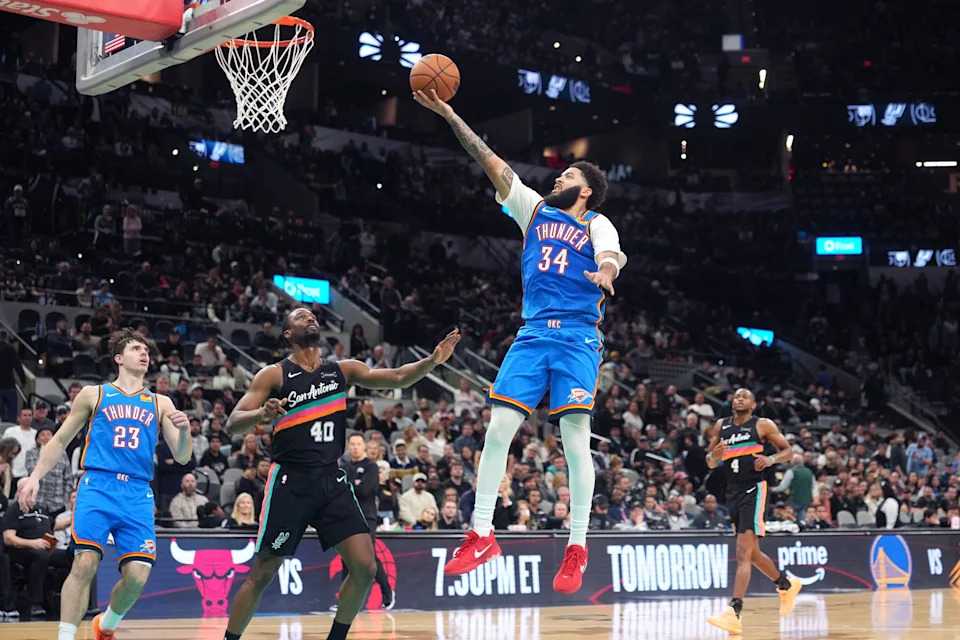 Feb 4, 2026; San Antonio, Texas, USA; Oklahoma City Thunder forward Kenrich Williams (34) drives to the basket against San Antonio Spurs forward Harrison Barnes (40) during the second half at Frost Bank Center. Mandatory Credit: Scott Wachter-Imagn Images