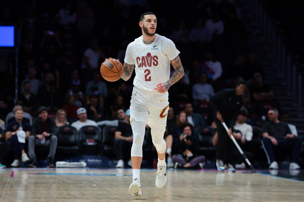 Caris LeVert dribbling the ball during a game between the Cleveland Cavaliers and the Miami Heat.