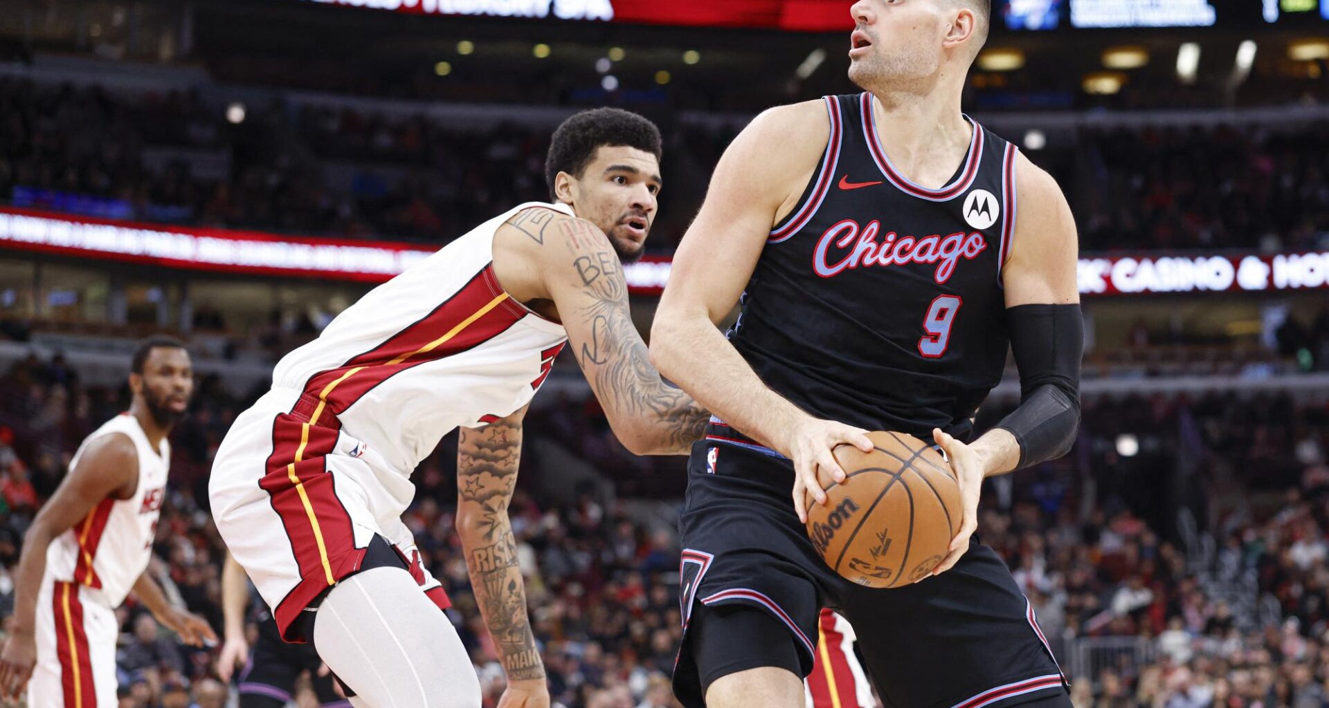 Jan 29, 2026; Chicago, Illinois, USA; Chicago Bulls center Nikola Vucevic (9) looks to shoot against Miami Heat center Kel'el Ware (7) during the first half at United Center. Mandatory Credit: Kamil Krzaczynski-Imagn Images