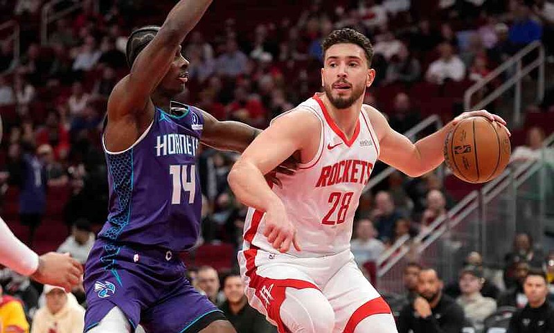 Houston Rockets center Alperen Sengun (28) controls the ball against Charlotte Hornets forward Moussa Diabate (14) during the first half of an NBA basketball game, Thursday, Feb. 5, 2026, in Houston. (AP Photo/ Karen Warren)