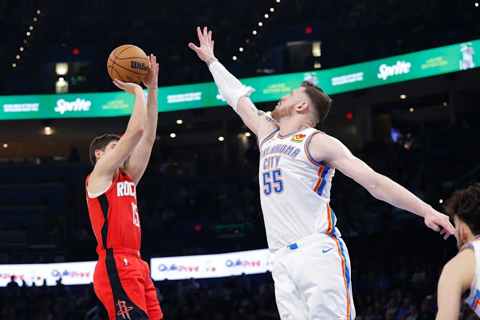 Feb 7, 2026; Oklahoma City, Oklahoma, USA; Houston Rockets guard Reed Sheppard (15) shoots as Oklahoma City Thunder center/forward Isaiah Hartenstein (55) defends during the second half at Paycom Center. Mandatory Credit: Alonzo Adams-Imagn Images