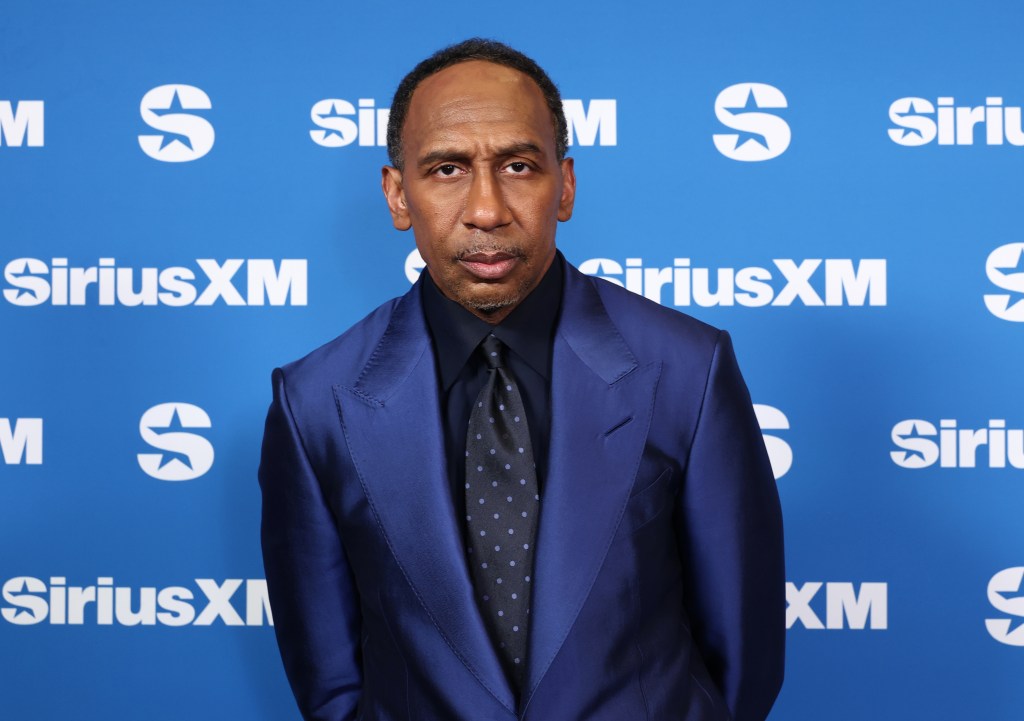 Stephen A. Smith in a blue suit and spotted tie against a blue background with the SiriusXM logo.