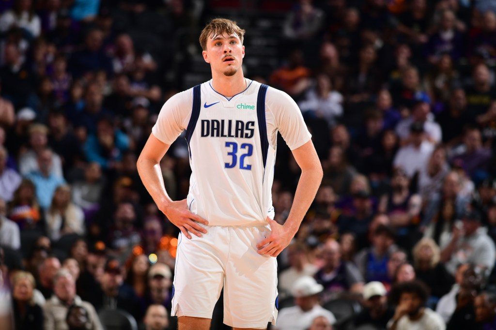 Dallas Mavericks player Davis Bertans in a white uniform with "DALLAS 32" on the front.