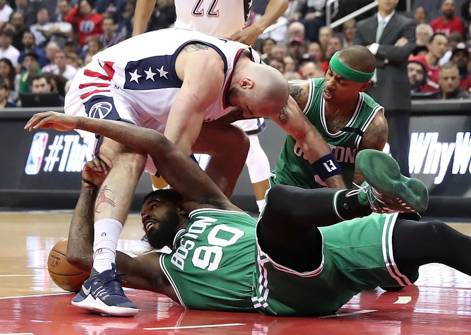 WASHINGTON, DC - MAY 12: Marcin Gortat #13 of the Washington Wizards scrambles for a loose ball against Amir Johnson #90 and Isaiah Thomas #4 of the Boston Celtics during Game Six of the NBA Eastern Conference Semi-Finals at Verizon Center on May 12, 2017 in Washington, DC. NOTE TO USER: User expressly acknowledges and agrees that, by downloading and or using this photograph, User is consenting to the terms and conditions of the Getty Images License Agreement. (Photo by Rob Carr/Getty Images)