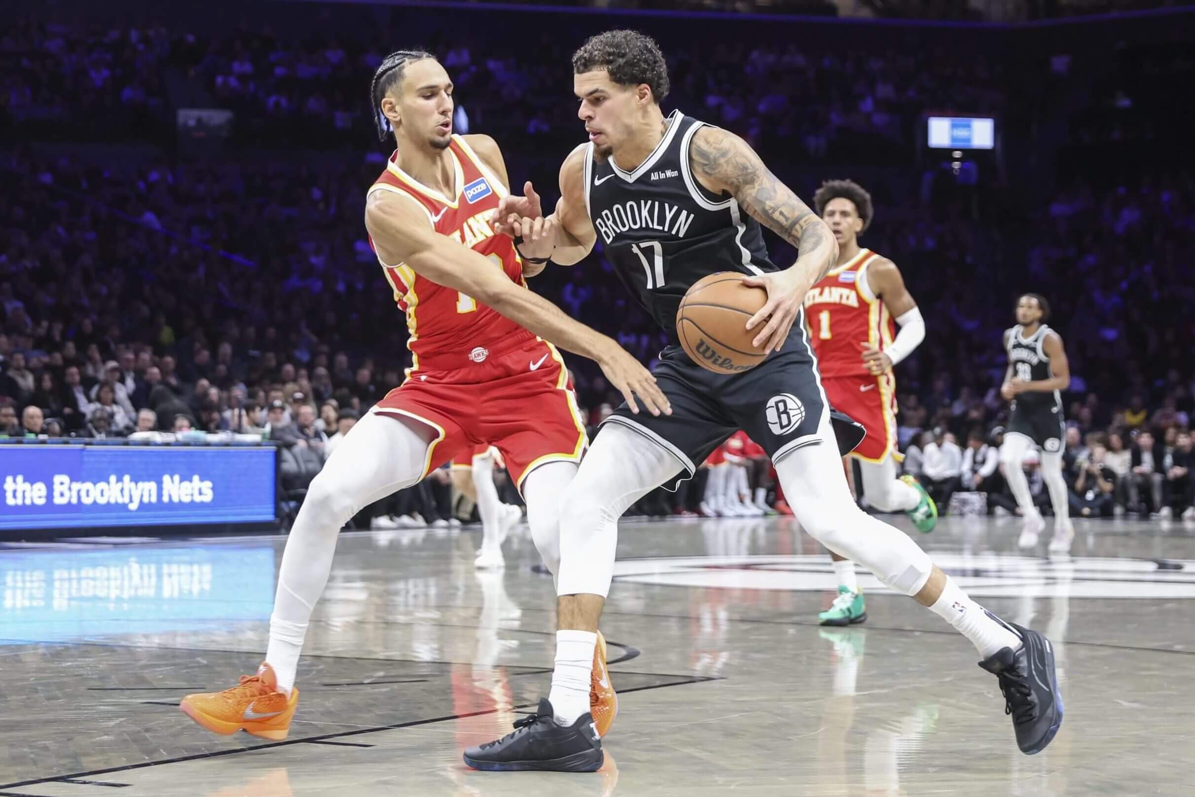 Michael Porter Jr. drives against Zaccharie Risacher 